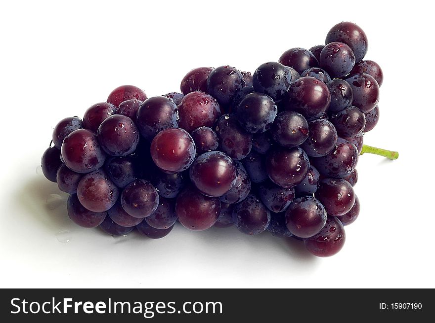 A cluster of fresh grapes isolated on a white background.