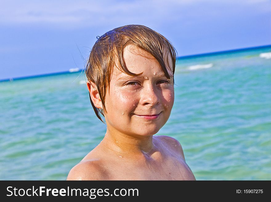 Boy enjoys the crystal clear water in the ocean. Boy enjoys the crystal clear water in the ocean