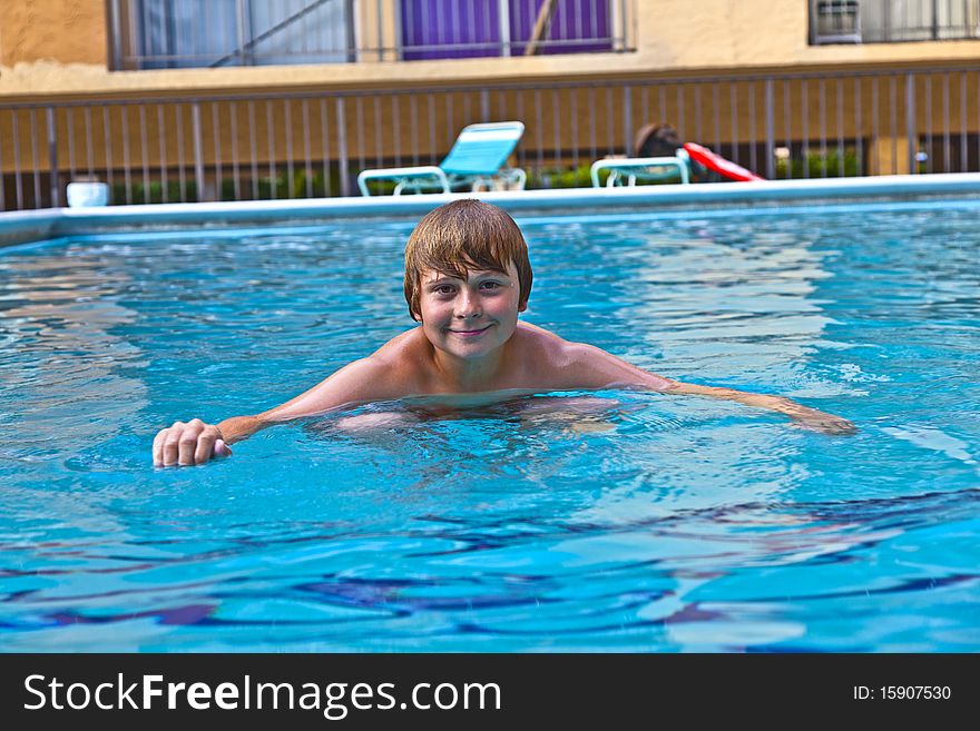 Boy enjoys swimming in the pool
