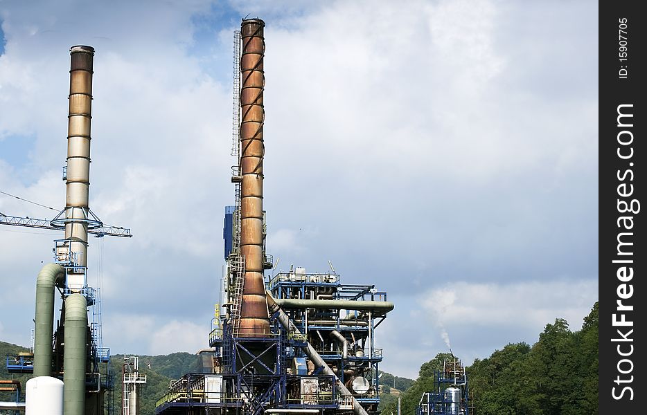 Blackened chimneys of an oil refinery in Italy