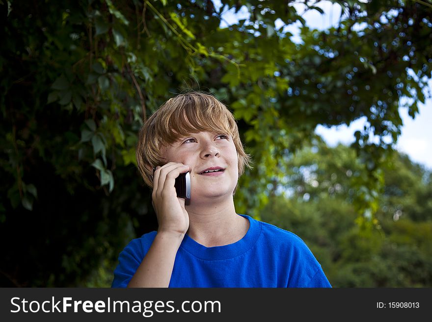 A young boy talking on a cell phone.