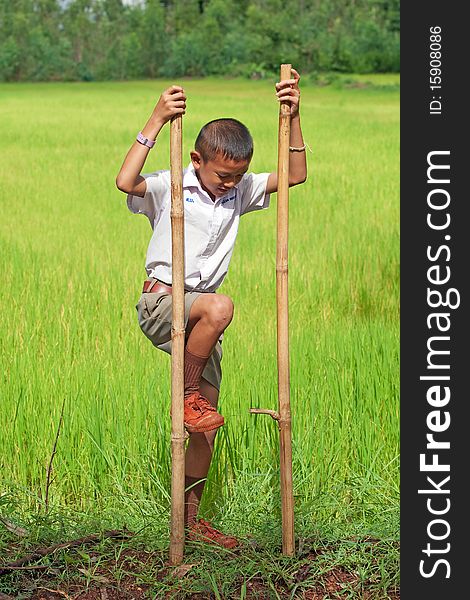 Boy goes on stilts, thai child with school uniform with his hobby