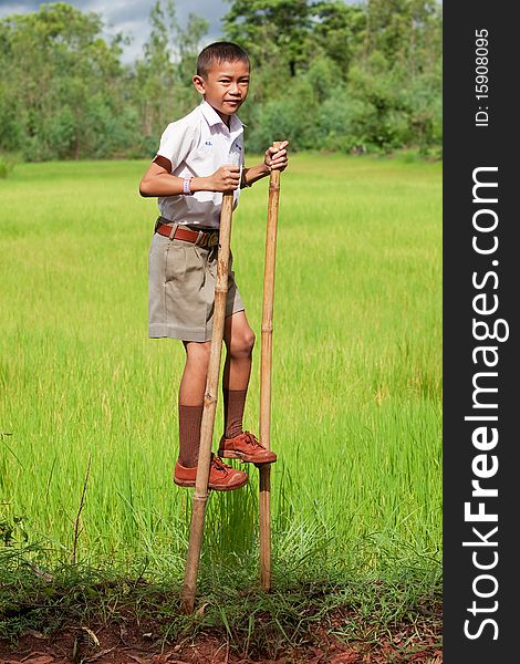 Boy goes on stilts, thai child with school uniform with his hobby
