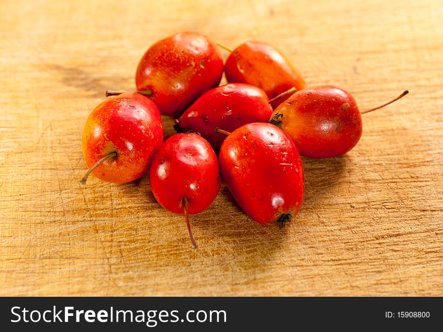 Cluster of Crab Apples on a wooden chopping board