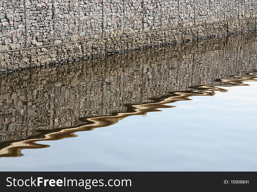 Steep river bank and its reflection in water. Steep river bank and its reflection in water