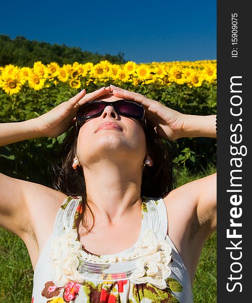 Young beautiful woman on field in summer