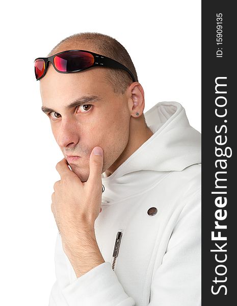 Pensive young man in a white jacket with sunglasses