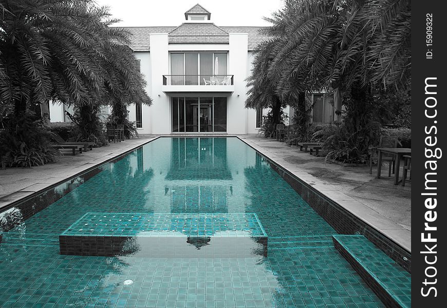 A view of a enchanted oriental style house with long swimming pool. A view of a enchanted oriental style house with long swimming pool
