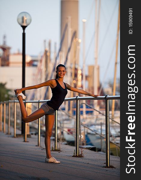 Young woman doing stretching before jogging