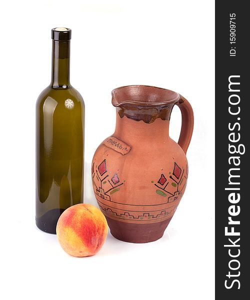 Wine bottle, pot and peach isolated on white background. Wine bottle, pot and peach isolated on white background.