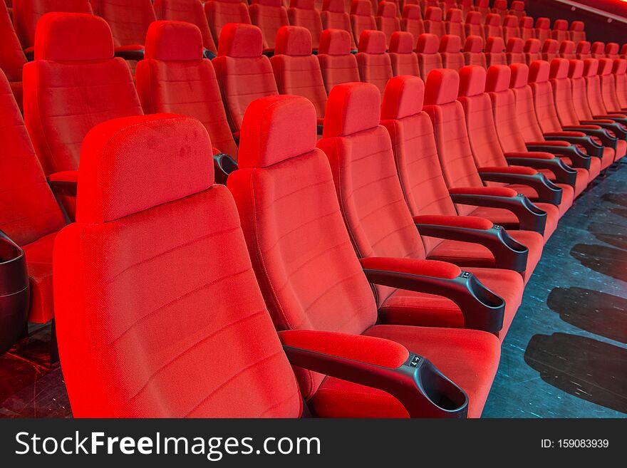 Movie Theatre seating with armrests and drink holders