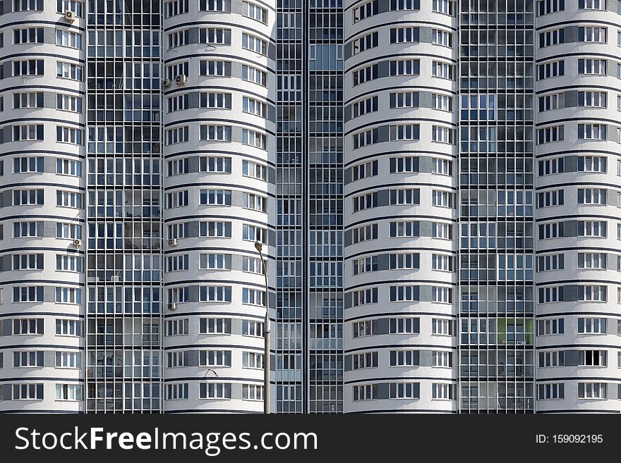 Close-up of high multiple dwelling building with wavy walls. Close-up of high multiple dwelling building with wavy walls