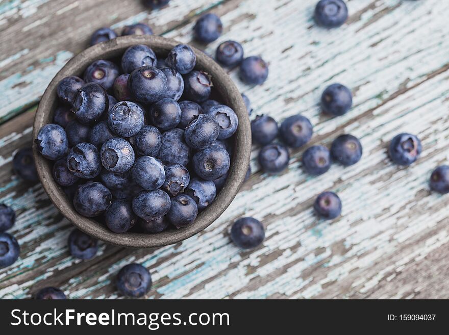 Ripe blueberry berries on old wooden table