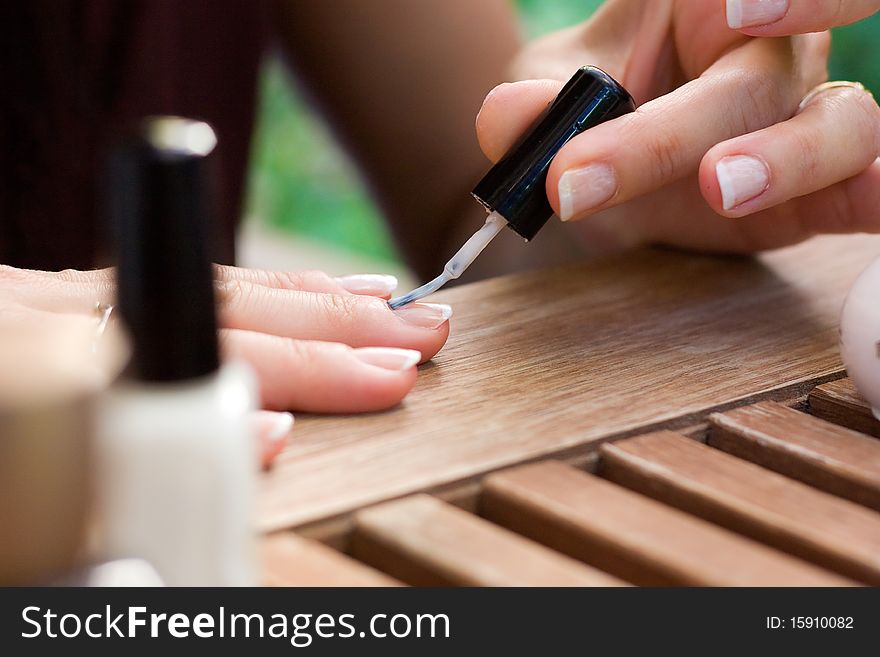 Applying nail polish on female fingers