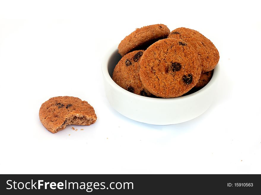 Chocolate cookies in a bowl, isolated on white background