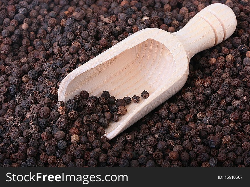 Spice - Black pepper with wooden spoon.