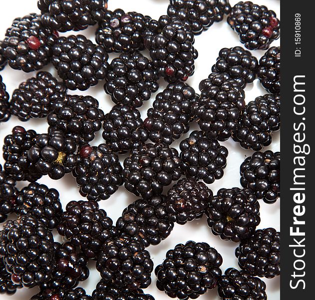 Composition of black raspberries on white isolated background in studio