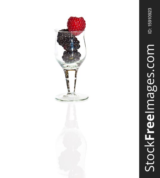 Composition of black and red raspberries on white isolated background in studio