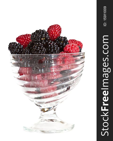 Composition of black and red raspberries on white isolated background in studio