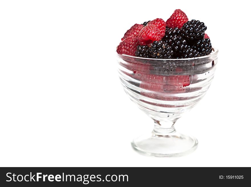 Composition of black and red raspberries on white isolated background in studio