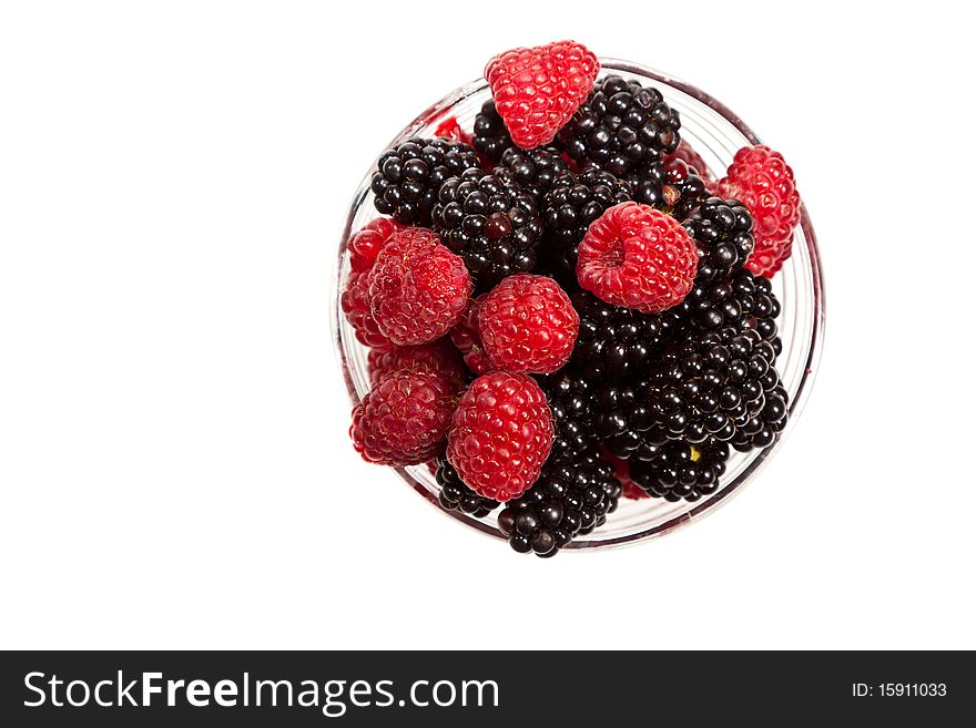 Composition of black and red raspberries on white isolated background in studio