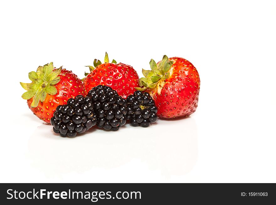 Composition of ripe black and red raspberries and strawberries. Composition of ripe black and red raspberries and strawberries