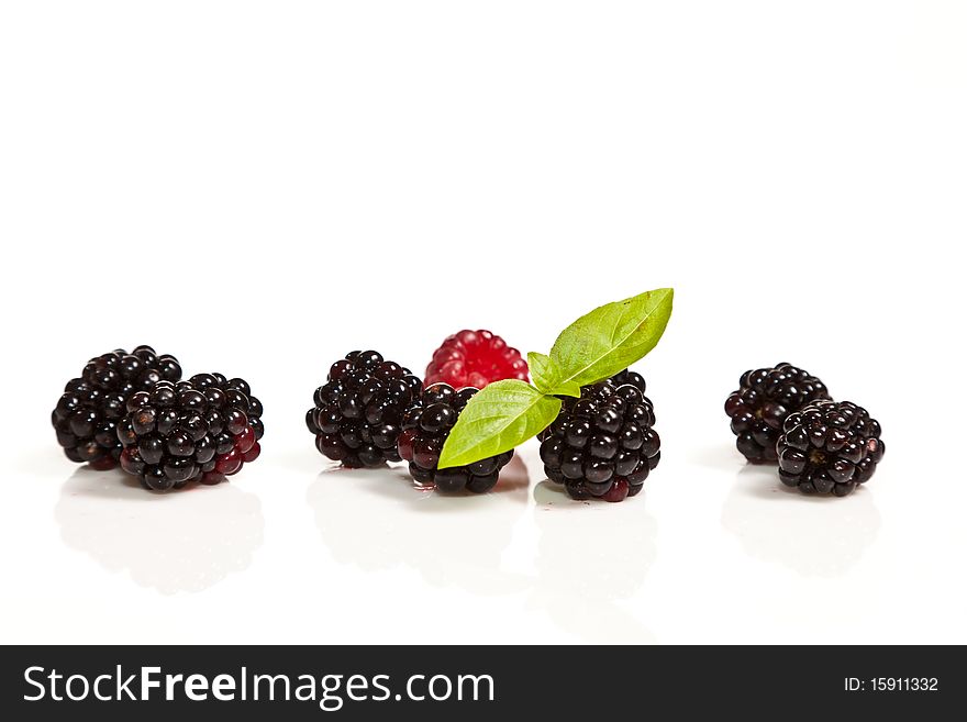 Ripe Black and red raspberries on white isolated background