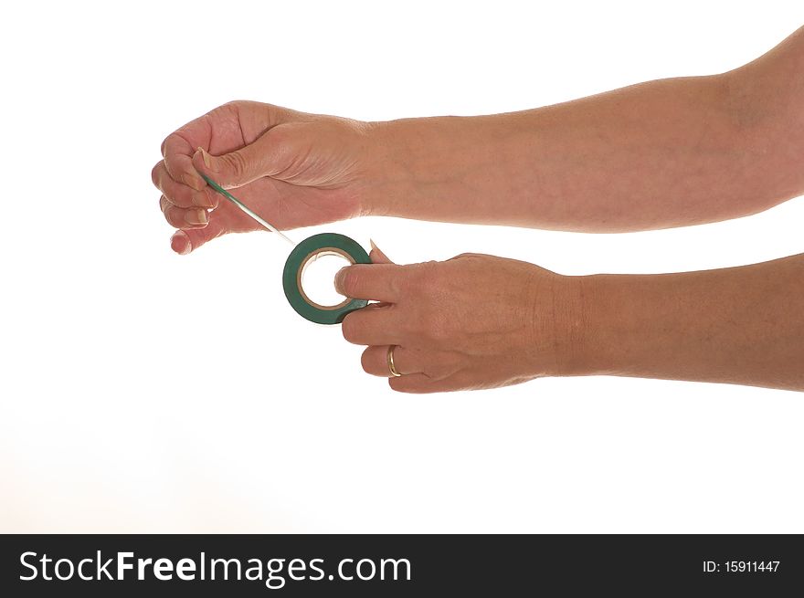 Hands holding a roll of green insulating tape