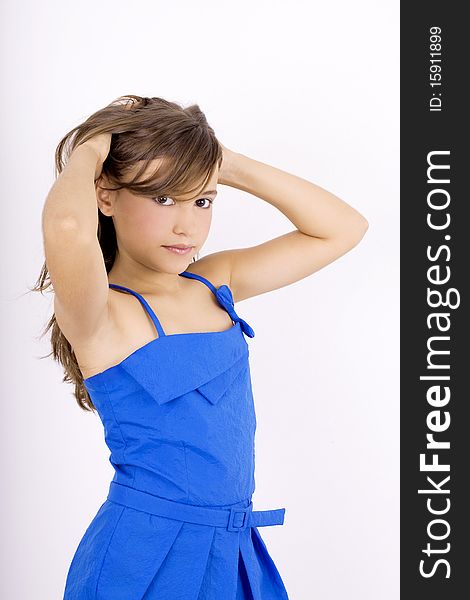 Teenage girl in a blue dress holding her hair. Teenage girl in a blue dress holding her hair