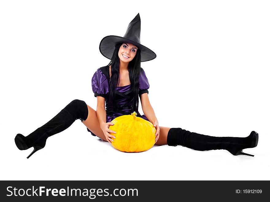 Pretty young brunette woman dressed as a fairy with  pumpkins. Pretty young brunette woman dressed as a fairy with  pumpkins