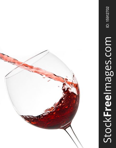 Wine glass pouring red wine. Wine glass pouring red wine