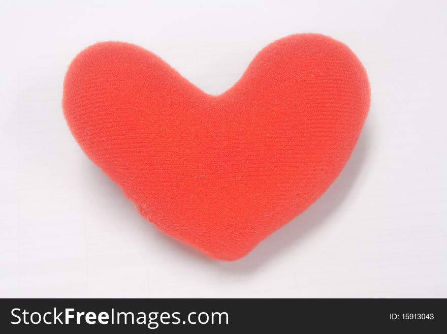 A red stuffed fabric heart.