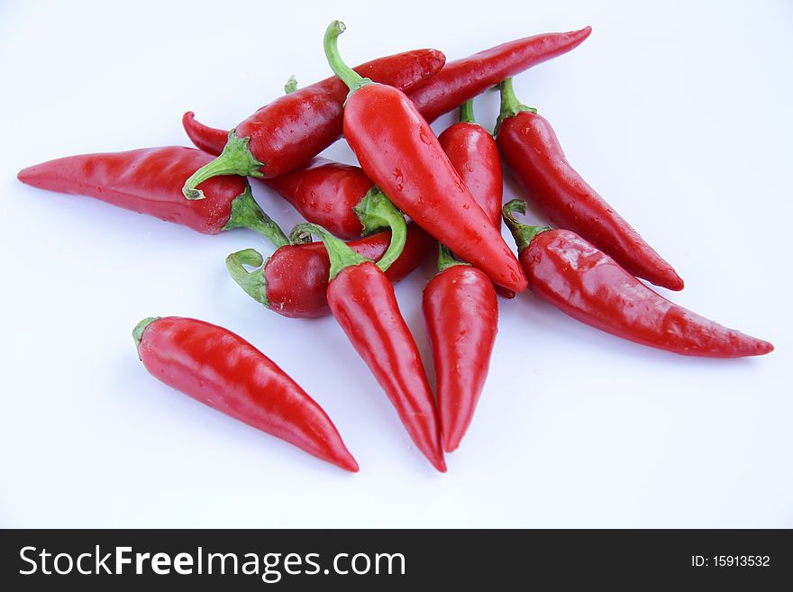 A lot of red chili pepper on a white background