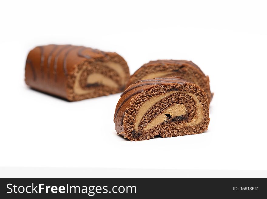 Sliced chocolate cake on white background