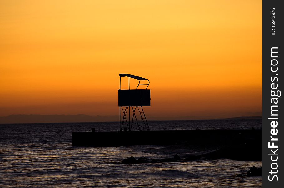 Romantic sunset background, lifeguard tower
