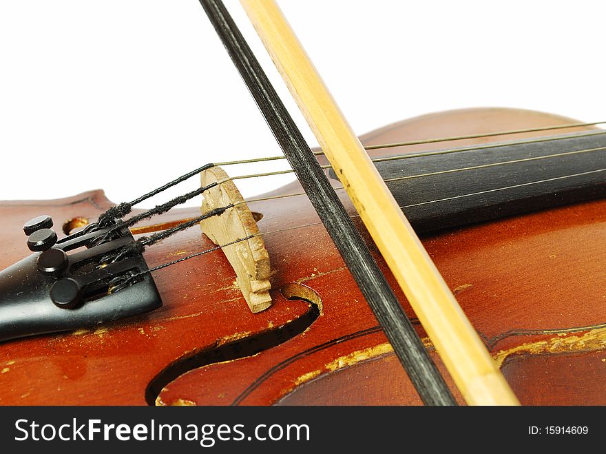 Violin with the bow on a white background close-up of strings. Violin with the bow on a white background close-up of strings