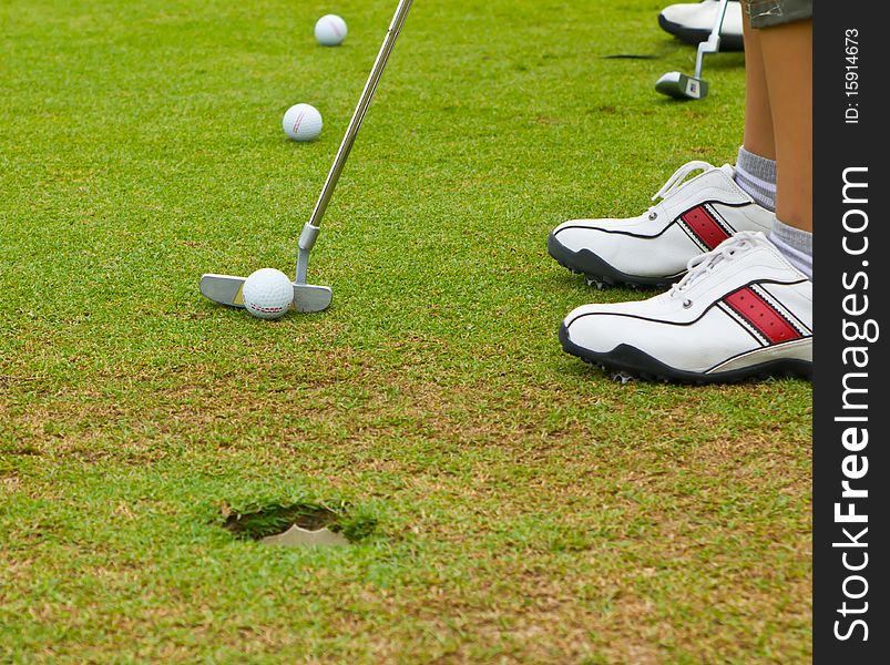 Putt golf on green course  field