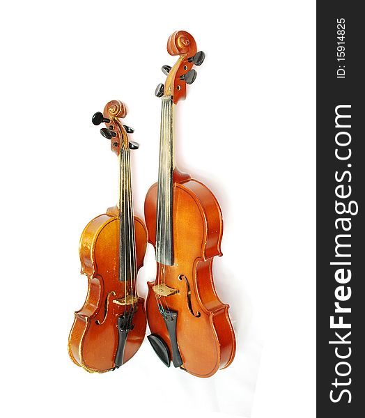 Two violins on a white background a little more the other is smaller. Two violins on a white background a little more the other is smaller