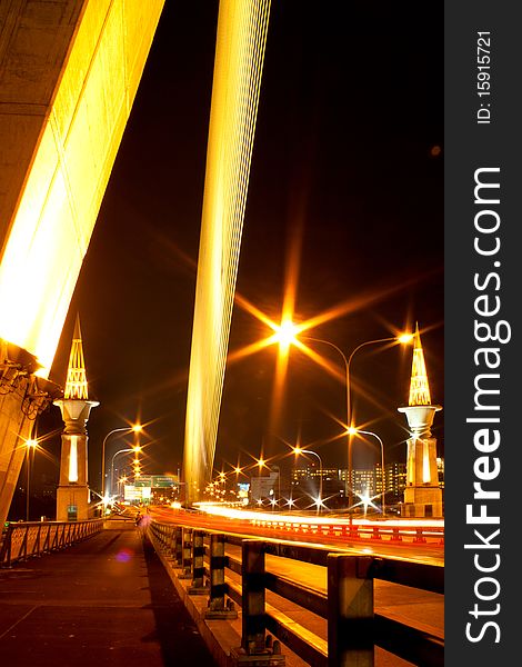 Rama 8 Bridge at night in Bangkok.