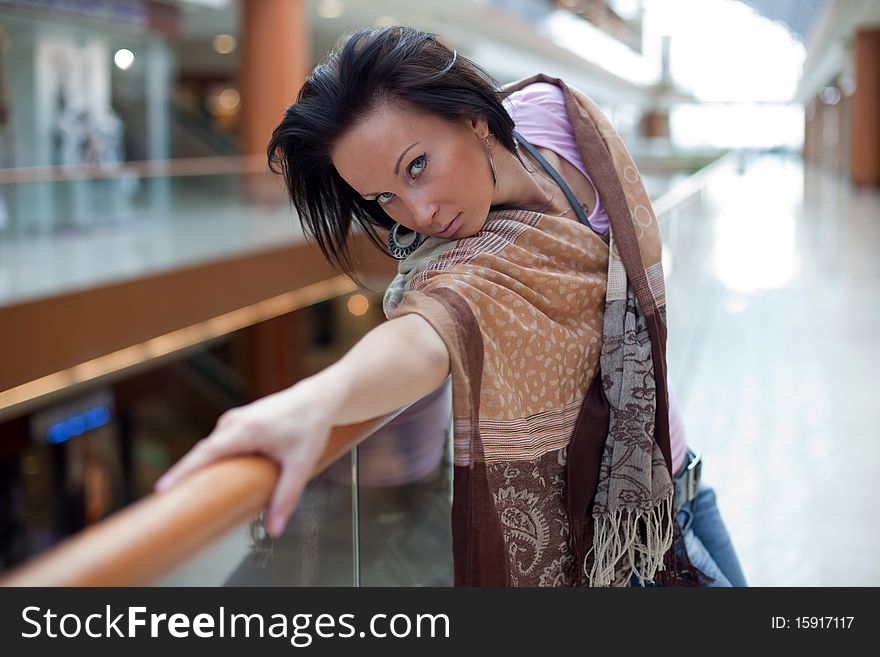 Portrait of a girl posing over mall background. Portrait of a girl posing over mall background