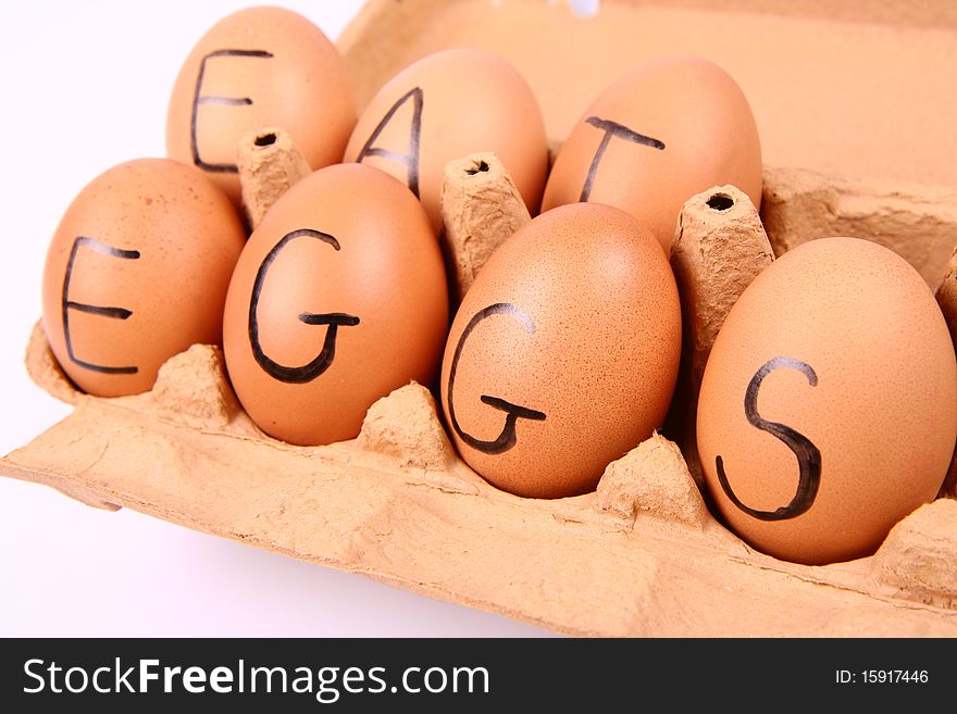 Eggs with an inscription EAT EGGS in an egg carton