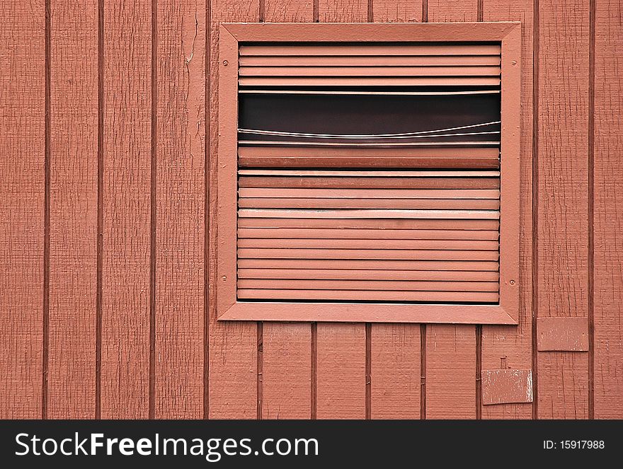 Bent orange vent on an orange wooden wall. Bent orange vent on an orange wooden wall