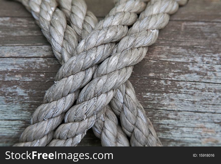 Detail of ropes lashed to a wood post. Detail of ropes lashed to a wood post