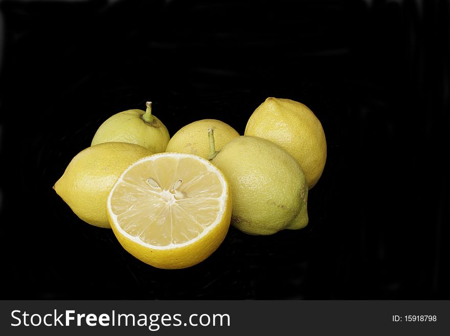 Ripe yellow lemons in isolated over black