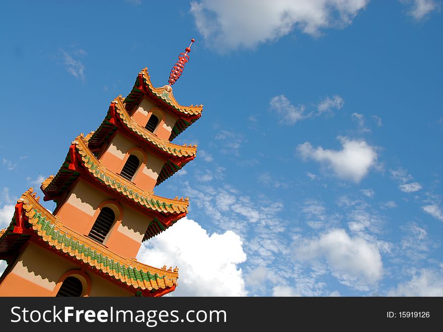 Chinese architecture set against a blue cloudy sky. Chinese architecture set against a blue cloudy sky.