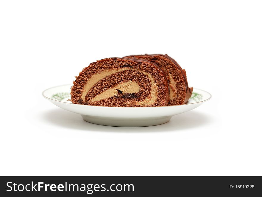 Two pieces of chocolate cake lying on china saucer