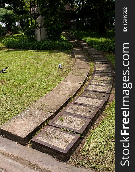 Sidewalk on grass in the park, curve sidewalk on the park. Sidewalk on grass in the park, curve sidewalk on the park