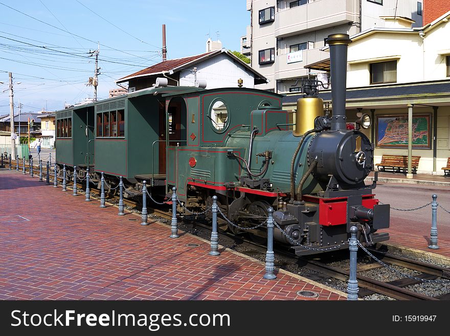 Small steam train in the middle of a city. Small steam train in the middle of a city