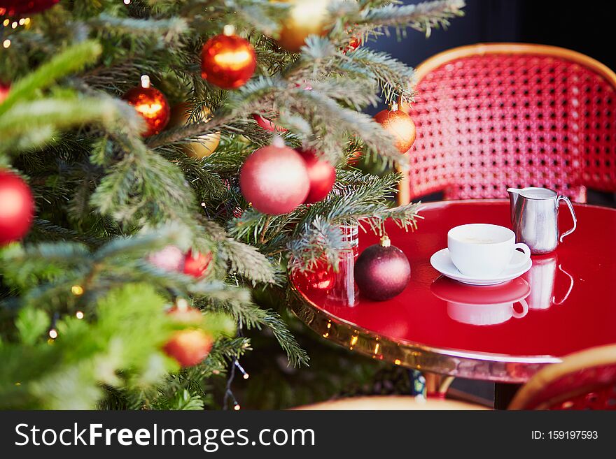 Outdoor Parisian cafe with beautiful Christmas tree decorated for season holidays