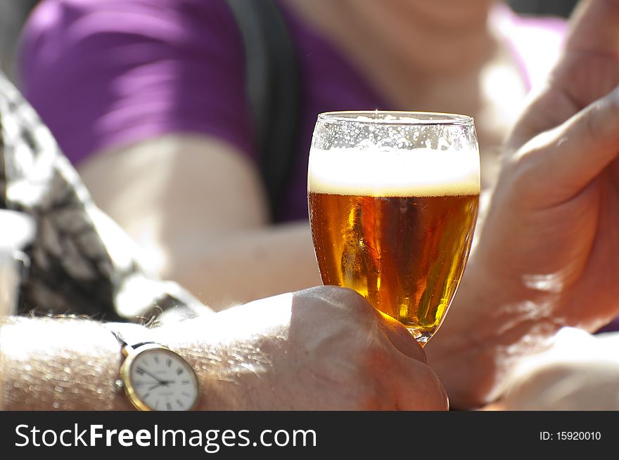 Man holding a glass of cold beer. Man holding a glass of cold beer